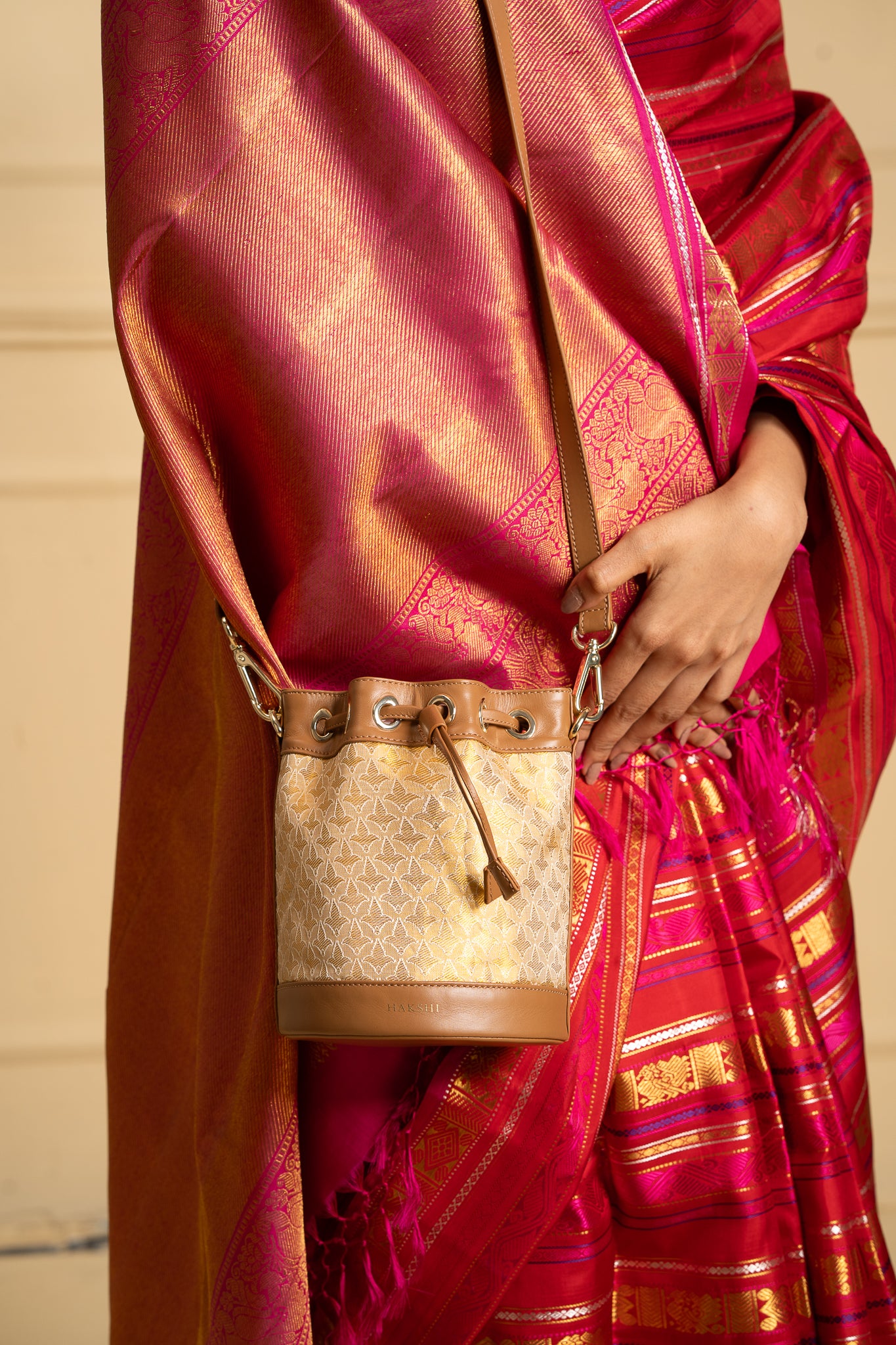 Genuine leather Kanchi Tissue Potli Bag featuring intricate weaving, a fusion of traditional craftsmanship and luxury material for a sophisticated accessory.