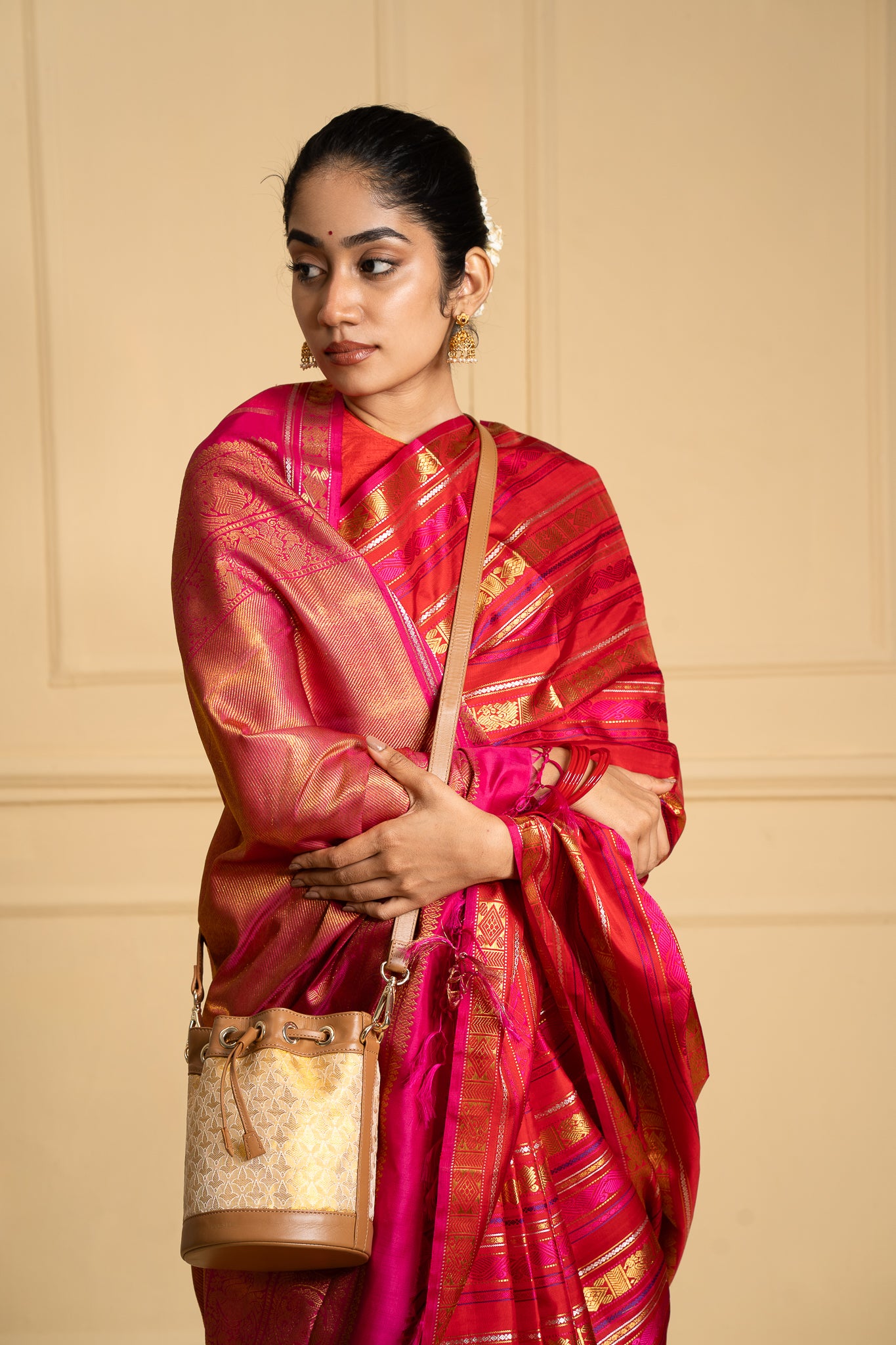 Model showcasing the exquisite Kanchi Tissue Potli Bag, a fusion of traditional weaving and modern design, adding sophistication to any look