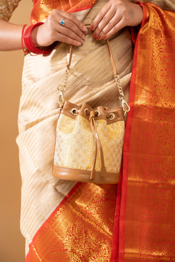 Traditional model gracefully holding a Potli Bag, showcasing exquisite craftsmanship and cultural heritage in every detail.